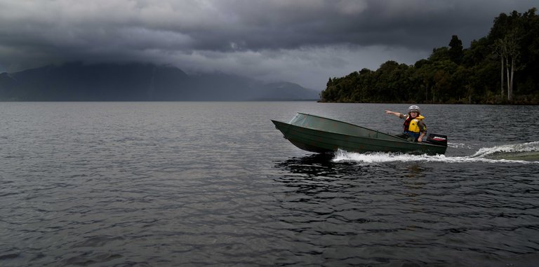Wide shot of Te Radar boating at Lake Brunner