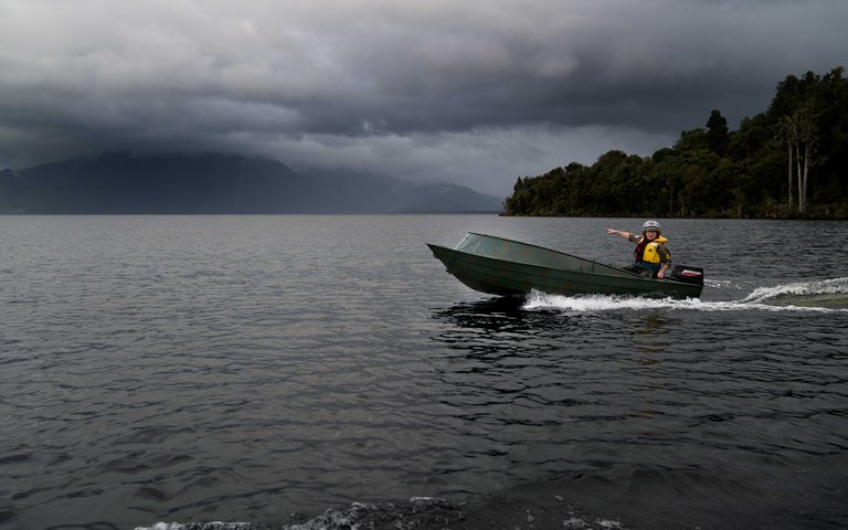 Wide shot of Te Radar boating at Lake Brunner